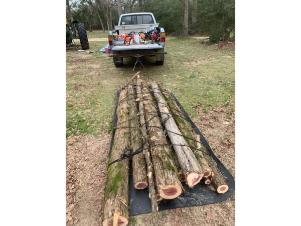 Yard Glider Hauling Logs Behind Truck