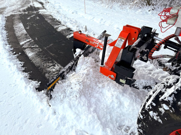 Rear Blade Clearing Snow on Paved Driveway