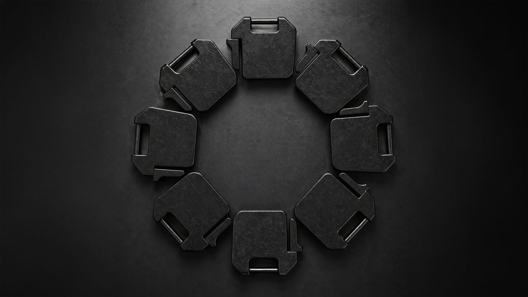 radial arrangement of suitcase weights on dark background
