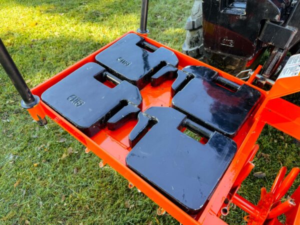 Four 70 lb Suitcase Weights on one half of the weight tray