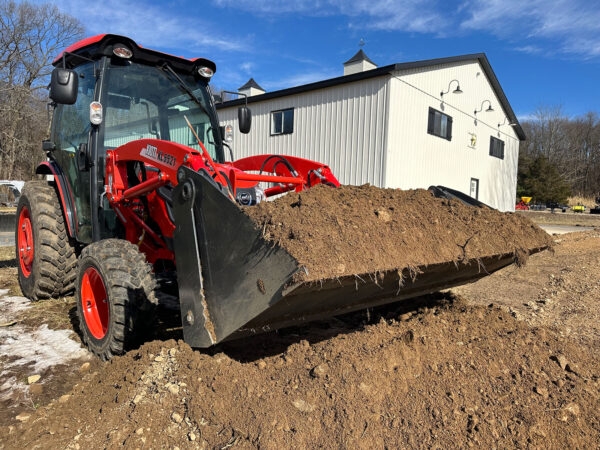 4-N-1 Bucket in Closed Position Scooping Dirt