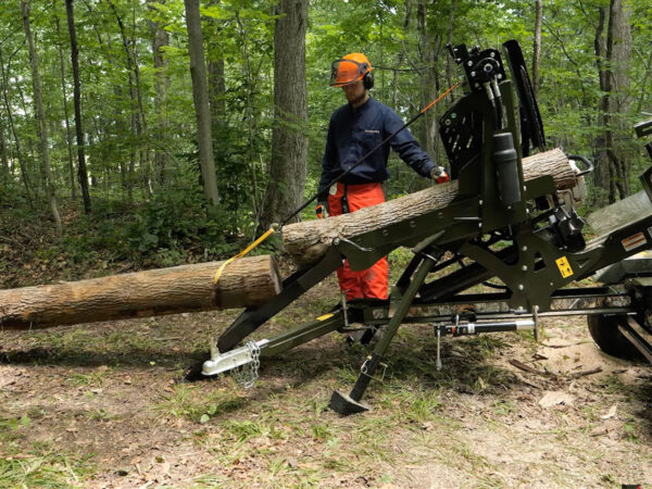 Winching a second log onto the loader chute