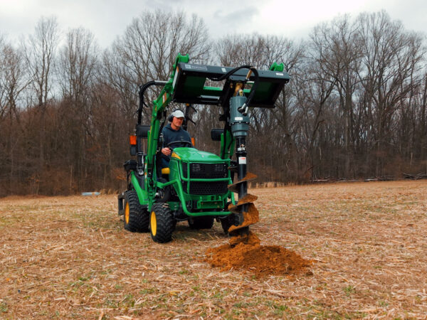 Front View of IronCraft 1500 Hydraulic Auger with Hydraulic Power Pack on John Deere 1025R