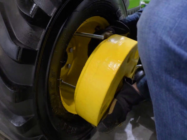 Sliding the wheel weight over the bolts