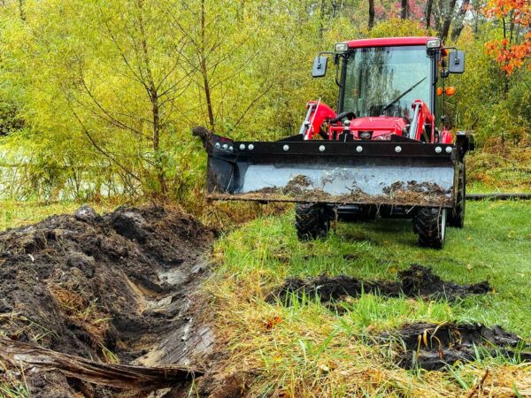 Digging a trench with the VersaPusher in the bucket position